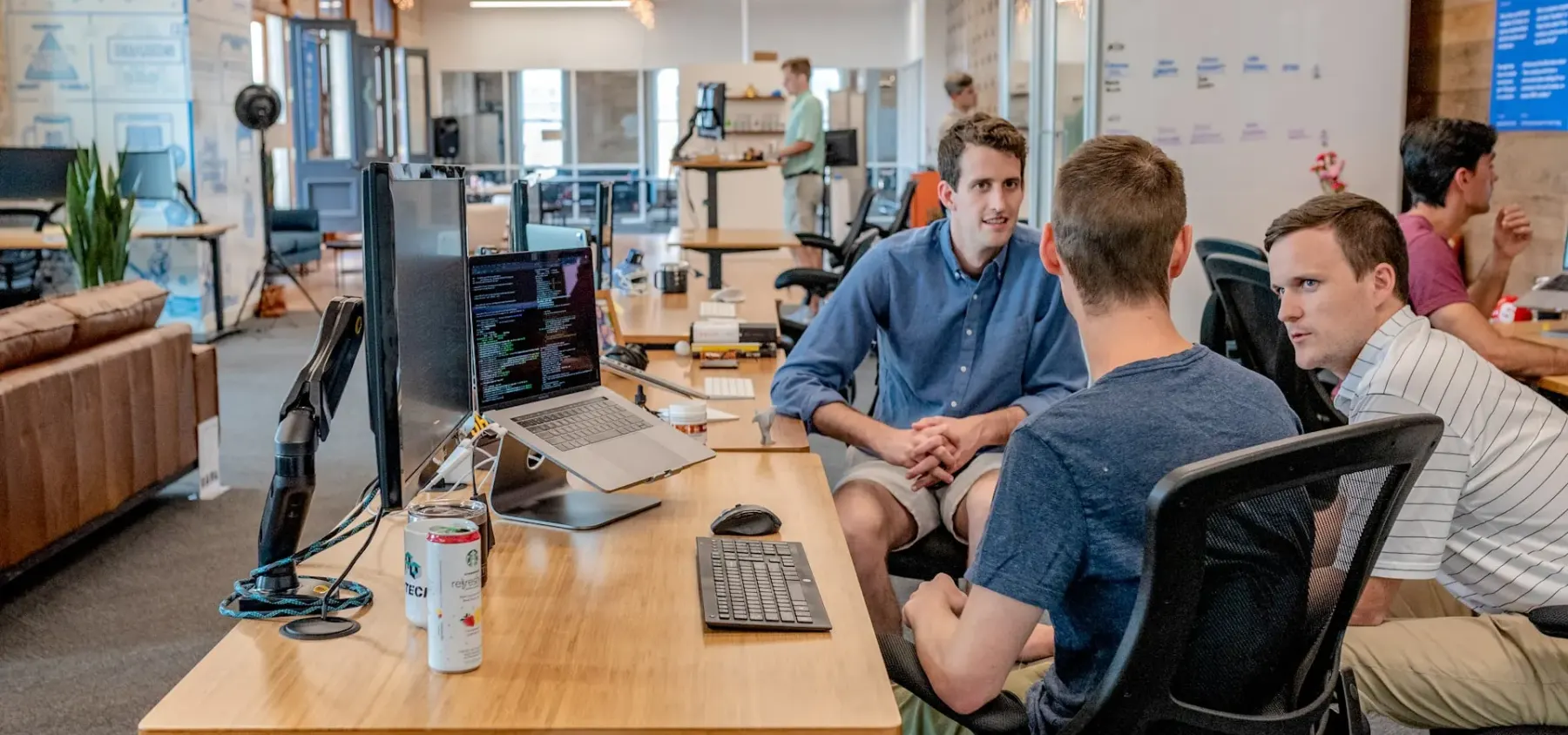 Colleagues meeting in an open-plan office